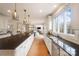 Kitchen with island, hardwood floors, and large window at 3012 Wheatfield Dr, Waxhaw, NC 28173