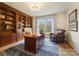 Study with built-in wooden bookshelves and a comfortable armchair at 3012 Wheatfield Dr, Waxhaw, NC 28173