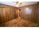 Bedroom featuring wood paneling, ceiling fan, carpet, and closet at 2725 Carla Dr, Shelby, NC 28150