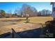 View of a spacious driveway with a basketball hoop, surrounded by a well-maintained yard and mature trees at 2725 Carla Dr, Shelby, NC 28150