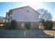 Exterior view of home with a brick foundation, walkout basement and side deck with stairs to the backyard at 2725 Carla Dr, Shelby, NC 28150