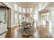 Elegant dining room features a round table, chandelier, and large windows with plantation shutters at 300 Eagle Bend Dr, Waxhaw, NC 28173