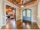 Elegant entryway with hardwood floors, arched doorway, and views into a wood-paneled office at 300 Eagle Bend Dr, Waxhaw, NC 28173