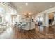 Open kitchen with white cabinetry, a large island, and hardwood floors at 300 Eagle Bend Dr, Waxhaw, NC 28173