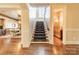 Elegant staircase with patterned runner, hardwood floors, and views of adjacent rooms at 300 Eagle Bend Dr, Waxhaw, NC 28173