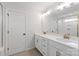 Bright bathroom featuring double vanity sinks, white cabinets, gold hardware, and a large framed mirror at 4684 Hopsack Dr # Cal0105, Indian Trail, NC 28079