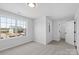 A bright bedroom with neutral carpet and a large window, with an attached walk-in closet at 4684 Hopsack Dr # Cal0105, Indian Trail, NC 28079