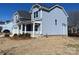 Two-story light blue house with a white porch at 4684 Hopsack Dr # Cal0105, Indian Trail, NC 28079