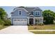 Charming two-story home features a light blue exterior, a two-car garage, and manicured front lawn at 4684 Hopsack Dr # Cal0105, Indian Trail, NC 28079