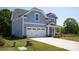 Two story home featuring a light blue exterior, two-car garage, and beautifully landscaped front yard at 4684 Hopsack Dr # Cal0105, Indian Trail, NC 28079