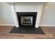 Modern fireplace with dark surround and wood mantel at 4684 Hopsack Dr # Cal0105, Indian Trail, NC 28079