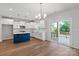 Modern kitchen with hardwood floors, island with seating, stainless appliances, and access to outdoor deck at 4684 Hopsack Dr # Cal0105, Indian Trail, NC 28079