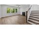 Spacious living room with a cozy fireplace, staircase and large windows, creating a perfect space to relax at 4684 Hopsack Dr # Cal0105, Indian Trail, NC 28079