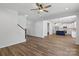 Bright, open-concept living room leads to the kitchen with a staircase and hardwood floors at 4684 Hopsack Dr # Cal0105, Indian Trail, NC 28079