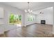 Living room with hardwood floors and fireplace leads to an outdoor deck through sliding glass doors at 4684 Hopsack Dr # Cal0105, Indian Trail, NC 28079
