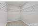 Empty walk-in closet with wire shelving and neutral carpet flooring at 4684 Hopsack Dr # Cal0105, Indian Trail, NC 28079
