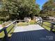 Backyard featuring a grey deck with green grass and sheds at 6261 Burnhurst Ln, Denver, NC 28037