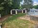 Backyard with two storage sheds and stairs to a wooden deck, showcasing an organized outdoor space at 6261 Burnhurst Ln, Denver, NC 28037