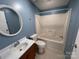Bathroom features a round mirror, single vanity, and shower-tub combo at 6261 Burnhurst Ln, Denver, NC 28037