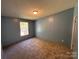 Bedroom featuring neutral carpet, window, and light blue walls at 6261 Burnhurst Ln, Denver, NC 28037
