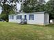 Charming single-story home featuring blue shutters and a spacious front lawn at 6261 Burnhurst Ln, Denver, NC 28037