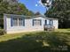 Inviting single-story house, showcasing blue shutters, set against a clear sky at 6261 Burnhurst Ln, Denver, NC 28037