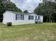 Charming single-story home featuring blue shutters and a spacious front lawn at 6261 Burnhurst Ln, Denver, NC 28037