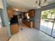 Bright kitchen features tile floors, wood cabinets, and a sliding glass door to the outside deck at 6261 Burnhurst Ln, Denver, NC 28037