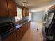 Functional kitchen with ample counter space, modern microwave, and views into the living area at 6261 Burnhurst Ln, Denver, NC 28037