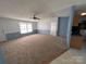 Spacious living room with carpeting, large windows, and neutral-toned walls with white trim at 6261 Burnhurst Ln, Denver, NC 28037