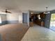 Open-concept living room connected to the kitchen, featuring updated flooring and plenty of natural light at 6261 Burnhurst Ln, Denver, NC 28037