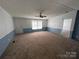 Comfortable living room bathed in natural light, featuring plush carpeting and a cozy atmosphere at 6261 Burnhurst Ln, Denver, NC 28037