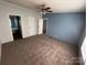 Generously sized primary bedroom featuring soft carpeting and easy access to the Primary bathroom and closet at 6261 Burnhurst Ln, Denver, NC 28037