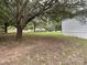 Side yard with mature trees and grassy area at 6261 Burnhurst Ln, Denver, NC 28037