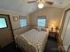 Comfortable bedroom featuring a white iron frame bed, ceiling fan, and cozy decor at 193 Marina Dr, New London, NC 28127