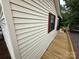 Exterior featuring vinyl siding with wooden porch and outdoor dining and lounge area at 193 Marina Dr, New London, NC 28127