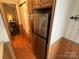 Hallway featuring a stainless steel refrigerator and connecting to the bedroom at 193 Marina Dr, New London, NC 28127