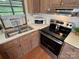 Efficient kitchen featuring a stainless steel oven and sink with backyard view at 193 Marina Dr, New London, NC 28127