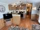 Functional kitchen with wood cabinets, modern appliances, and eat-in counter at 193 Marina Dr, New London, NC 28127