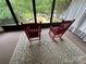 Inviting sunroom with a view of the lake featuring two classic red rocking chairs at 193 Marina Dr, New London, NC 28127