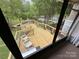 Spacious sunroom with a view of the lake, the deck, and white outdoor furniture at 193 Marina Dr, New London, NC 28127