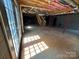 An unfinished basement with glass doors, exposed ceiling, and a concrete floor offering potential at 2290 9Th Avenue Ne Dr, Hickory, NC 28601