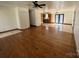 Bright living room with hardwood floors transitioning to tiled area, ceiling fan and kitchen access at 2290 9Th Avenue Ne Dr, Hickory, NC 28601