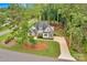 Areal view of a beautiful single Gathering home with stone and stucco exterior surrounded by mature trees at 7245 Static Way, Sherrills Ford, NC 28673