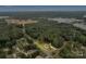 An aerial view of a wooded property with a cozy house, emphasizing its peaceful setting in a leafy neighborhood at 7245 Static Way, Sherrills Ford, NC 28673