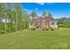 Expansive backyard with lush landscaping and pergola-covered patio at 7245 Static Way, Sherrills Ford, NC 28673