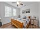 A cozy bedroom with natural light from two windows, a ceiling fan, and a comfortable bed at 7245 Static Way, Sherrills Ford, NC 28673