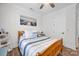 Bright bedroom featuring a bed with pillows, a ceiling fan, an art piece, and a white door at 7245 Static Way, Sherrills Ford, NC 28673