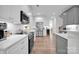 Modern kitchen with white cabinets, stainless steel appliances, and hardwood floors at 7245 Static Way, Sherrills Ford, NC 28673