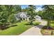 White farmhouse exterior with landscaping and driveway at 5811 Kristi Ln, Midland, NC 28107